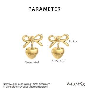 Detail view of 9g stainless steel bow heart earrings with 18k gold plating