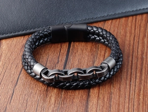 Detail of double-layer men's bracelet with black woven leather and silver metal chain