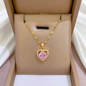 Elegant gold titanium necklace featuring a pink gemstone heart pendant and diamonds