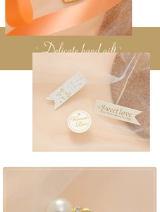 Detail view of round ivory gift tags with gold foil text and pre-punched hanging holes