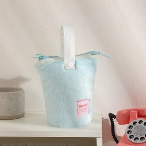 Detail of light blue plush standing pencil case with soft faux fur and brand tag