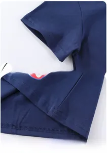 Detail of double-stitch seams and hem workmanship on a navy blue boys cotton t-shirt