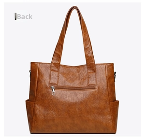 Back view of brown vintage tote bag featuring a horizontal zipper pocket and side pockets