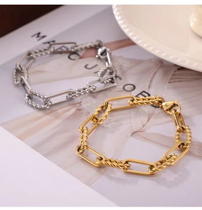 Detail of interlocking gold and silver titanium chain links with textured rope design