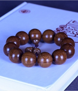 Close-up of Liudaomu wood prayer beads showing natural grain and smooth texture