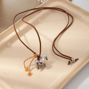Silver Dala horse pendant necklace with colorful woven tassels and brown cord detail