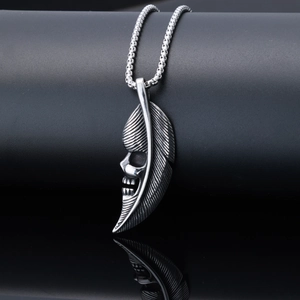 Vintage stainless steel necklace featuring a silver feather and skull pendant design