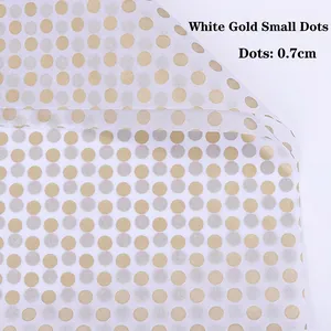 Macro detail of white and gold polka dot flower wrapping paper with 0.7cm dot size
