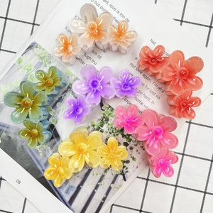 Set of six colorful gradient plumeria hair claws in vibrant floral resin designs