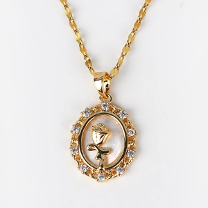 Detailed close-up of gold shell necklace with oval rose pendant and zircon inlay