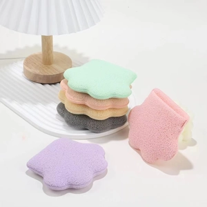 Detailed view of flower and paw shaped soft facial sponges in five pastel colors