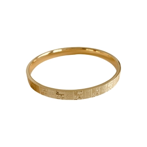 Minimalist gold open bangle with embossed mahjong pattern and character engravings