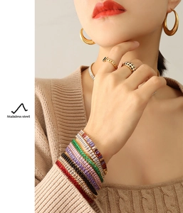 Detail view of colorful zircon stainless steel jewelry set worn by a model