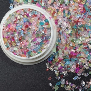 Irregular colorful glass shards in a jar for nail art and DIY jewelry making crafts