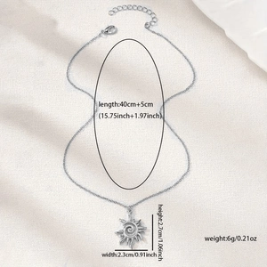 Retro silver alloy sun vortex pendant necklace with hollow spiral design on beige fabric