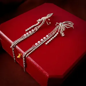 Elegant zircon butterfly long tassel ear clips with pearls on a red jewelry box