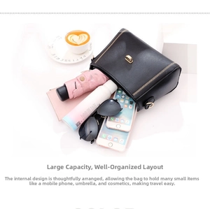 Interior view of black faux leather crossbody bag showing large storage capacity and lock