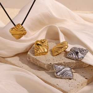18K gold plated stainless steel seashell necklace and earring set on stone background
