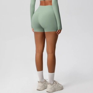Back view of high-waisted sage green yoga shorts showing lifting effect and seamless fit