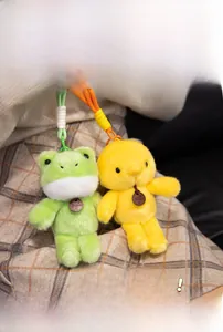 Close-up of cute plush frog and chick charms with woven lanyards and fashion tags
