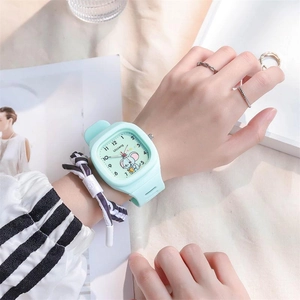 Close-up of mint green silicone watch with square dial and cartoon pattern on wrist