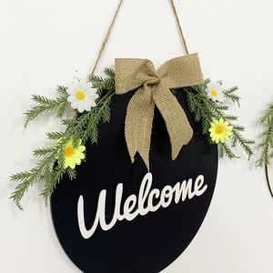 Round wooden Welcome sign with navy bow and faux greenery for front door decor