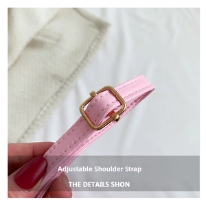 Detailed shot of pink leather adjustable shoulder strap with golden square buckle