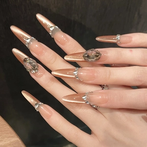 Long stiletto press-on nails with rose gold cat eye finish and luxury rhinestones