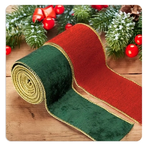 Close-up of red and green velvet Christmas ribbons with gold wired edges on wood