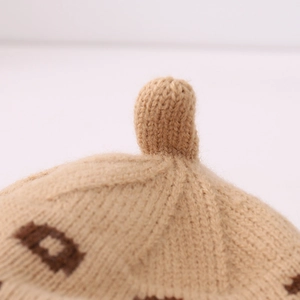 Macro shot of khaki knitted beret featuring dense knit texture and fine pattern detail