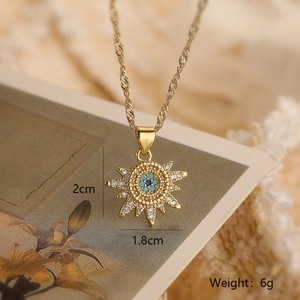 Macro view of 18K gold sun pendant necklace with blue zircon eye details and dimensions
