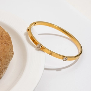 Gold plated stainless steel open bangle with sparkling cubic zirconia accents