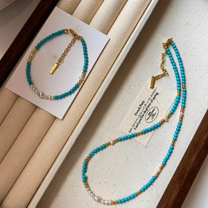 18K gold plated necklace with freshwater pearls and turquoise beads on velvet