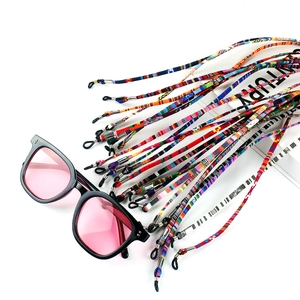 Detail of colorful bohemian woven eyeglass lanyards with metal clips and silicone loops