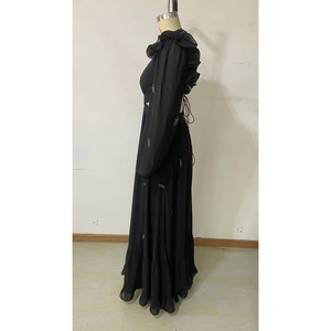 Detail of elegant black chiffon maxi dress featuring layered ruffles and silver sequins