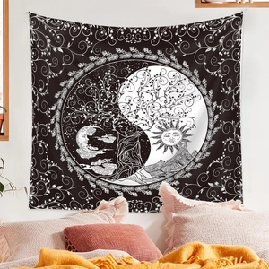 Detail of black and white bohemian tapestry featuring tree of life and sun moon symbols