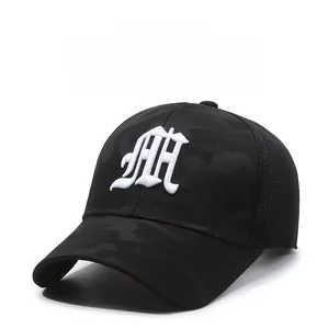 Close-up of black breathable mesh and gothic embroidery on the camouflage baseball cap