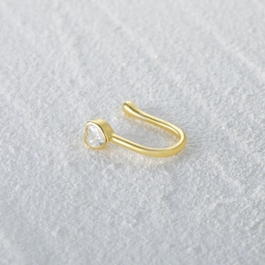 Macro shot of 925 silver heart shaped nose cuff with sparkling clear cubic zirconia