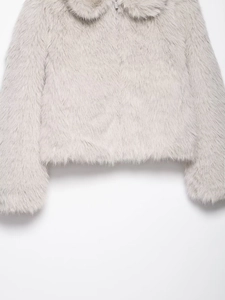 Detail of grey faux fur jacket showing plush texture and metallic zipper closure