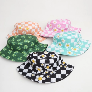 Close-up of five patterned bucket hats featuring checkerboard, daisies, and clover prints