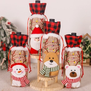 Detailed embroidery of Santa and Reindeer on burlap Christmas wine bottle covers
