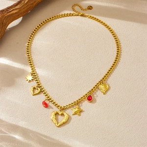 Gold stainless steel cuban chain necklace with winged heart, stars and red bead charms