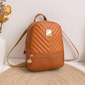 Brown mini backpack featuring V-quilted faux leather and a golden metal logo plate