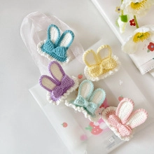 Handmade crochet bunny ear hair clips with bow details in five soft pastel colors