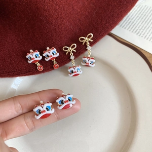 Detail of lion dance enamel earrings with pearls and coins in traditional Chinese style