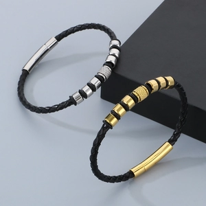 Detail of woven leather bracelet with gold and silver stainless steel geometric beads