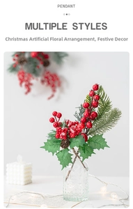 Detail of Christmas artificial floral pick with red berries and pine needles in a glass vase