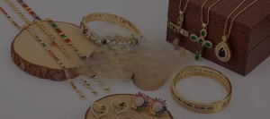 Detailed close-up of 18K gold plated jewelry set with colorful gemstones on wood