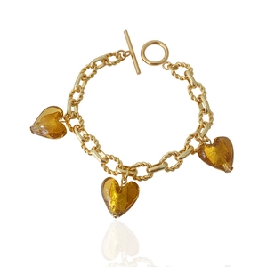 Detailed macro view of amber heart pendants with gold foil on an elegant OT buckle bracelet