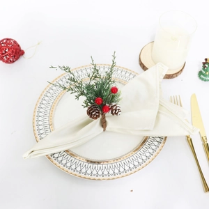 Rond de serviette de Noël avec aiguilles de pin, baies rouges et cônes sur une table